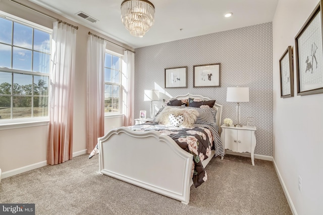 carpeted bedroom featuring wallpapered walls, an inviting chandelier, and baseboards
