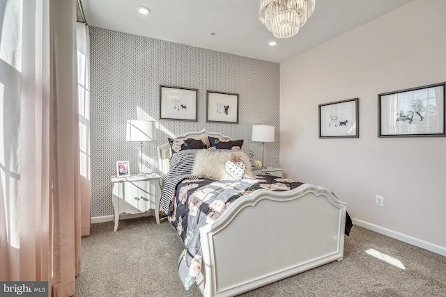bedroom featuring baseboards, carpet floors, an inviting chandelier, and wallpapered walls