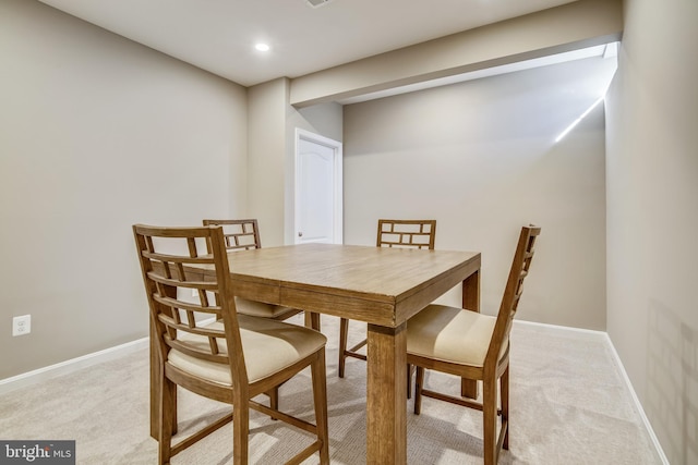 dining room with light carpet, recessed lighting, and baseboards