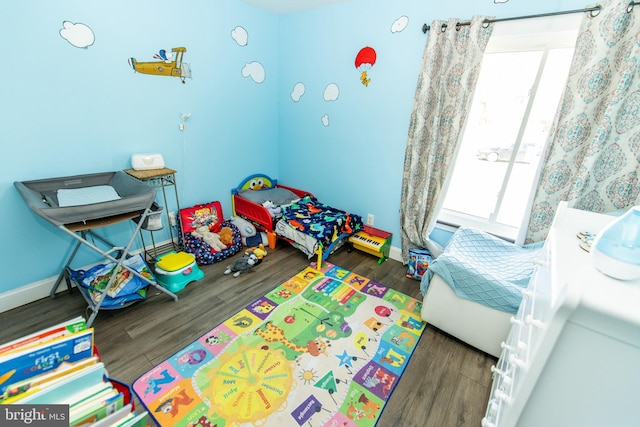 rec room with baseboards and wood finished floors