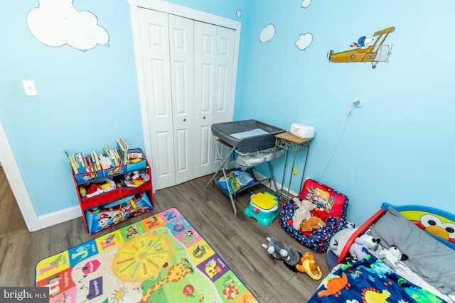playroom featuring baseboards and wood finished floors