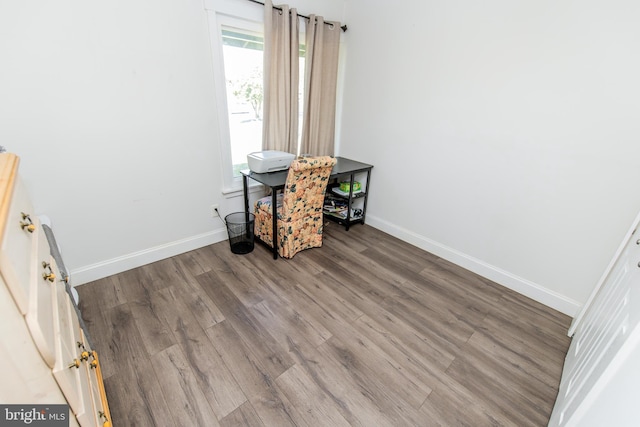 interior space with wood finished floors and baseboards