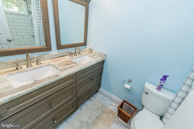 bathroom featuring toilet, marble finish floor, a sink, and baseboards