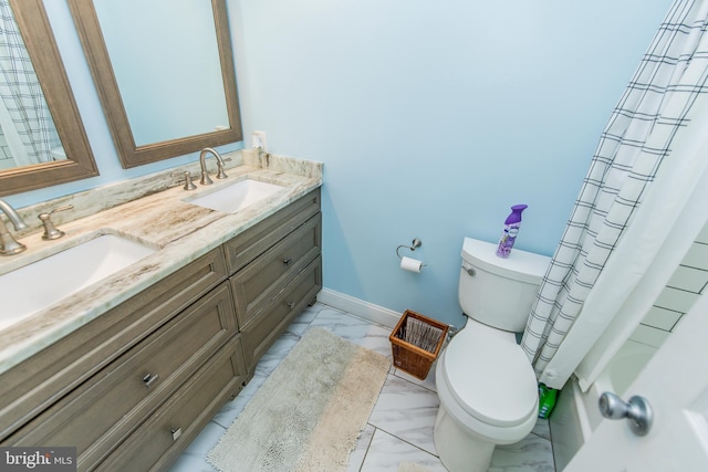 bathroom featuring baseboards, a sink, toilet, double vanity, and marble finish floor