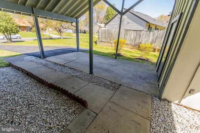 view of patio with fence and a residential view