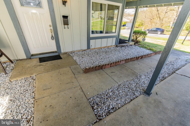 doorway to property featuring board and batten siding