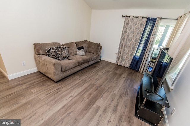 living area featuring baseboards and wood finished floors