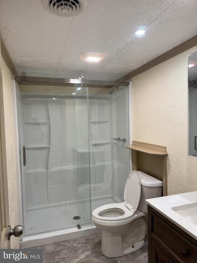 bathroom featuring visible vents, a shower stall, toilet, a textured wall, and vanity