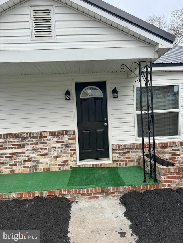 entrance to property with brick siding