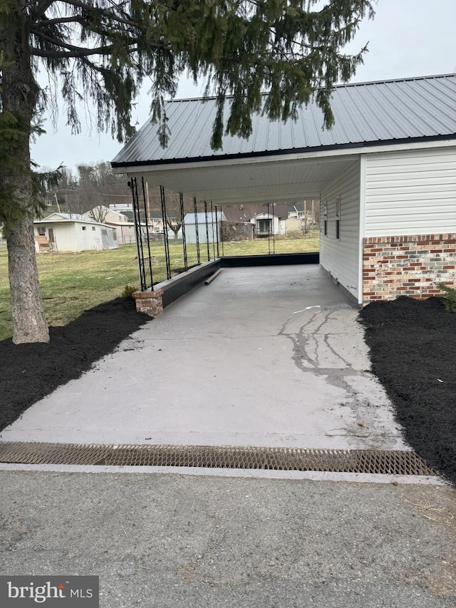view of vehicle parking featuring an attached carport and driveway