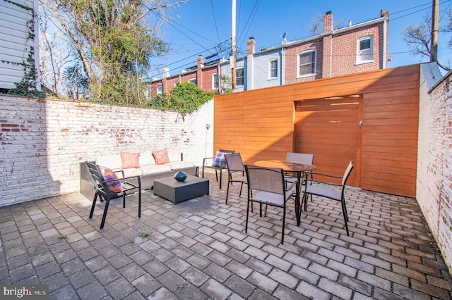 view of patio / terrace with outdoor lounge area and fence