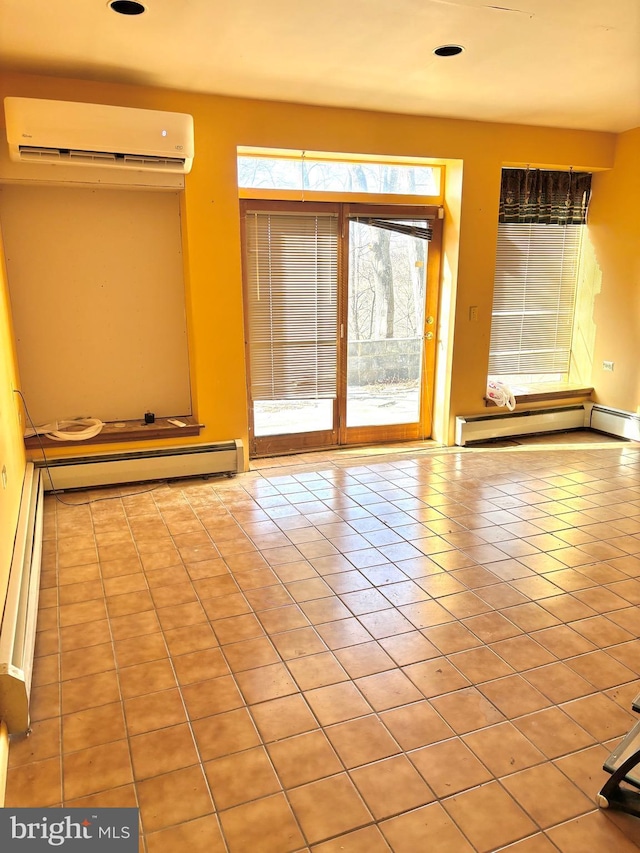 tiled empty room with a wall unit AC and a baseboard heating unit