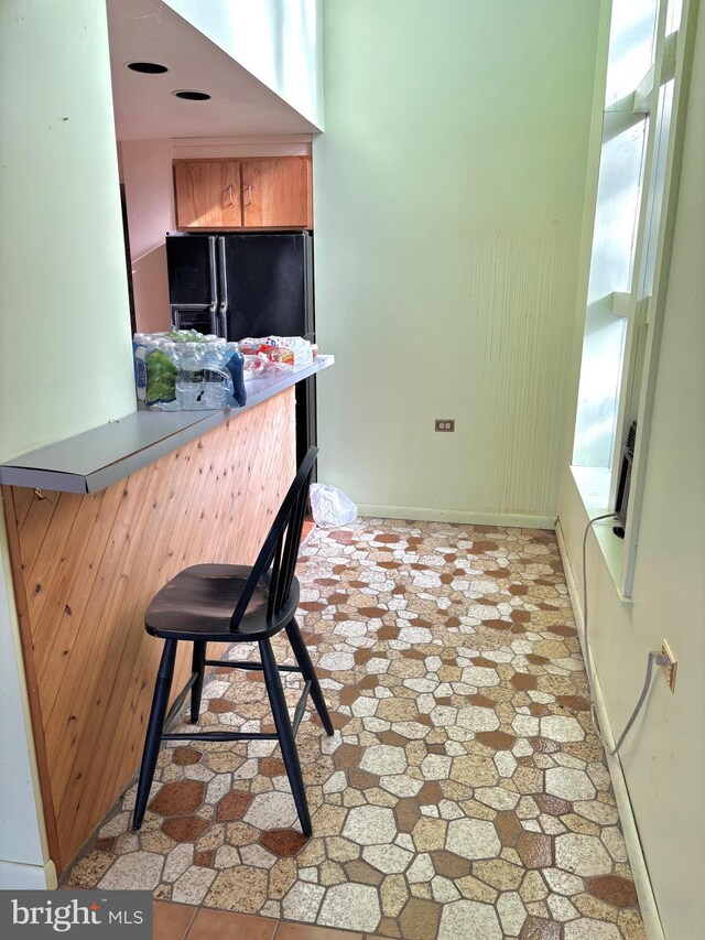 kitchen featuring black fridge with ice dispenser