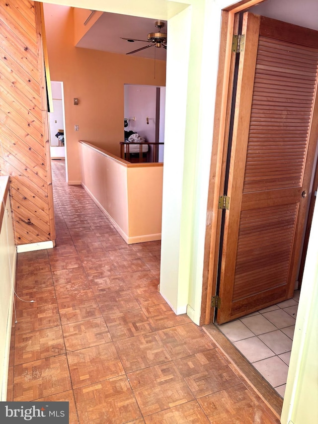 corridor featuring wood walls
