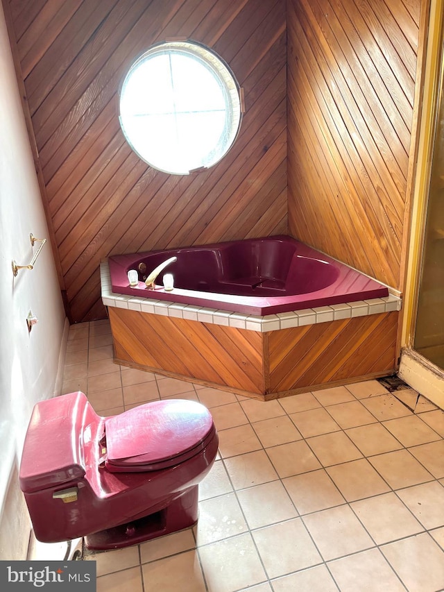 interior space featuring a bath, a stall shower, and tile patterned flooring