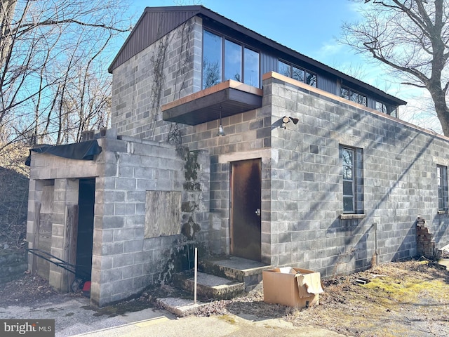 exterior space featuring concrete block siding and board and batten siding