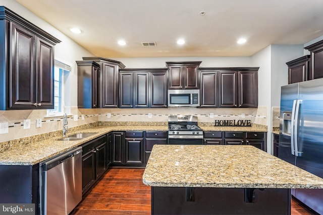 11351 Sandestin Pl, White Plains, MD 20695 - kitchen with light stone counters, visible vents, dark wood finished floors, a sink, and appliances with stainless steel finishes
