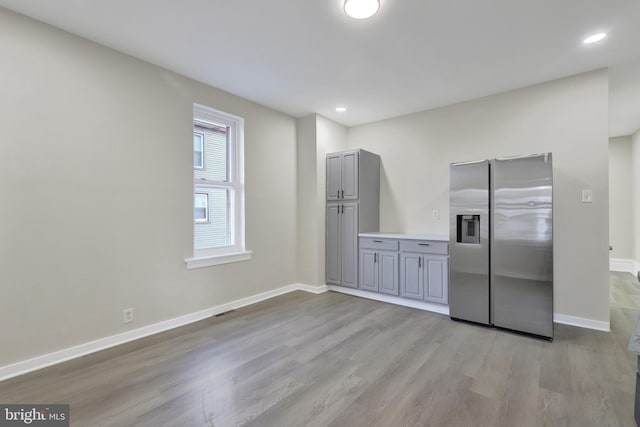 475-477 2nd St, Highspire, PA 17034 - kitchen with light wood-style floors, stainless steel fridge with ice dispenser, gray cabinets, and baseboards