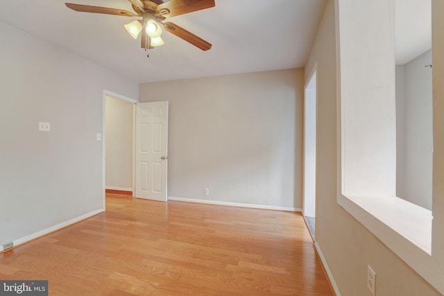 unfurnished room featuring baseboards, ceiling fan, and light wood finished floors