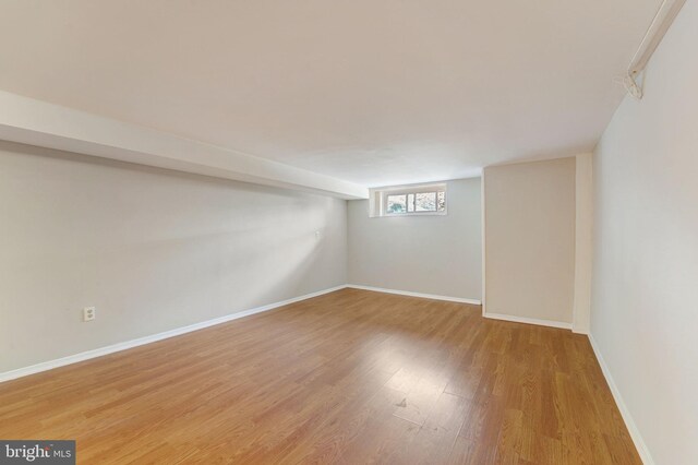 basement with wood finished floors and baseboards