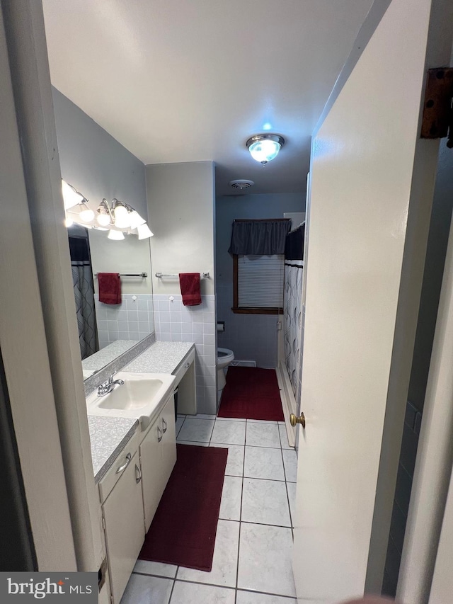10917 Kemper Dr, Williamsport, MD 21795 - full bathroom with vanity, tile patterned floors, toilet, and tile walls