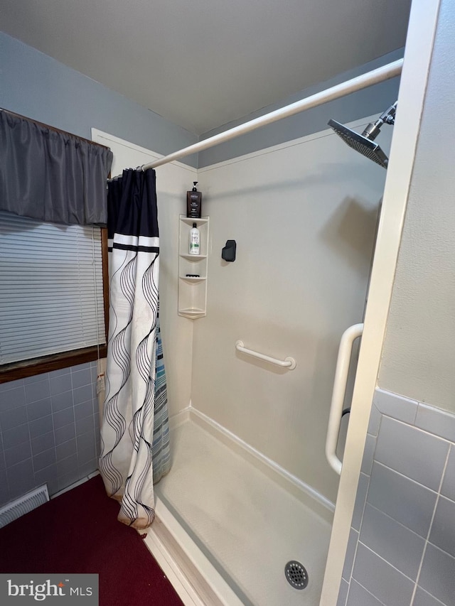 10917 Kemper Dr, Williamsport, MD 21795 - bathroom with a shower with shower curtain, tile walls, and visible vents