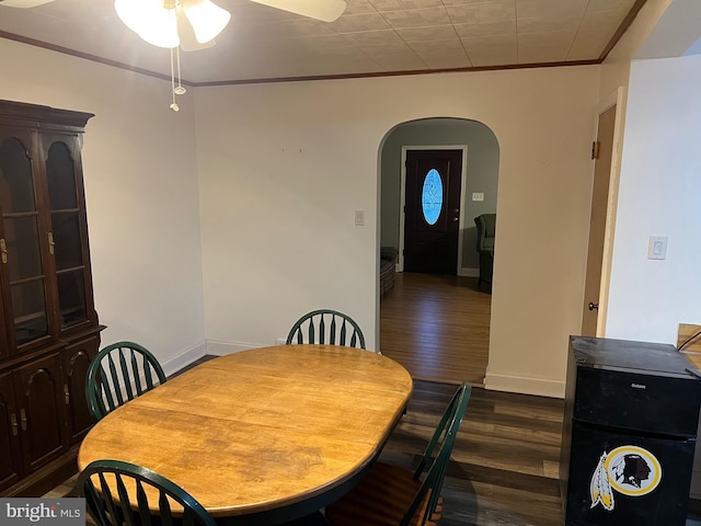 10917 Kemper Dr, Williamsport, MD 21795 - dining space with dark wood-type flooring, baseboards, ornamental molding, arched walkways, and a ceiling fan