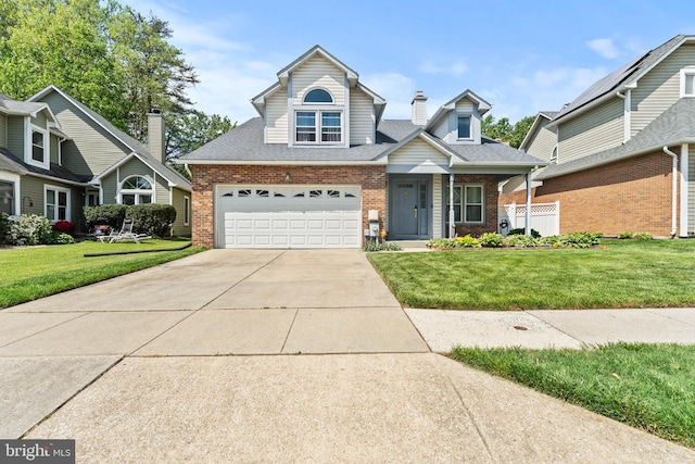view of front facade with concrete driveway, an attached garage, a front lawn, and brick siding