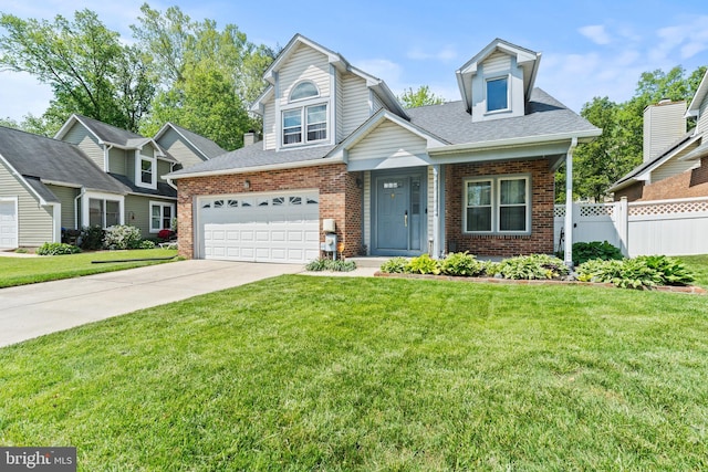 view of front of property with concrete driveway, brick siding, a front lawn, and fence