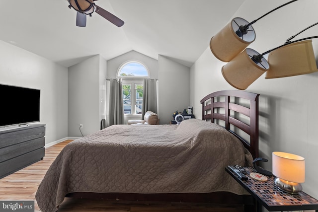 bedroom featuring lofted ceiling, baseboards, a ceiling fan, and wood finished floors