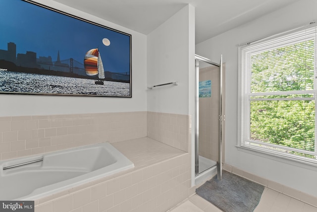 full bath with a healthy amount of sunlight, tile patterned flooring, a shower stall, and a bath