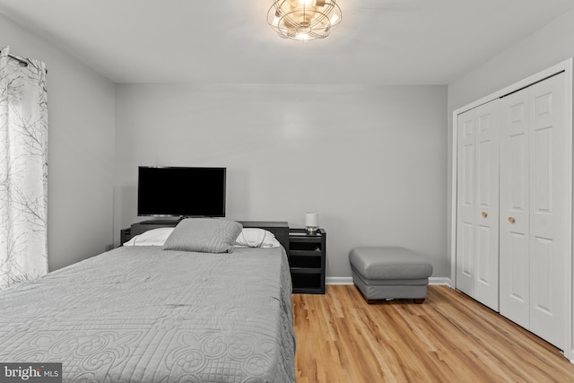 bedroom featuring a closet, baseboards, and wood finished floors
