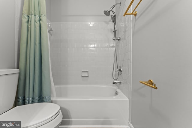 bathroom featuring toilet and shower / bath combination with curtain