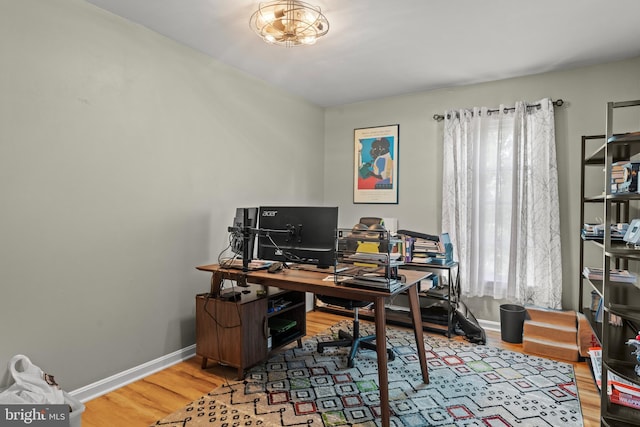 office space with baseboards and wood finished floors