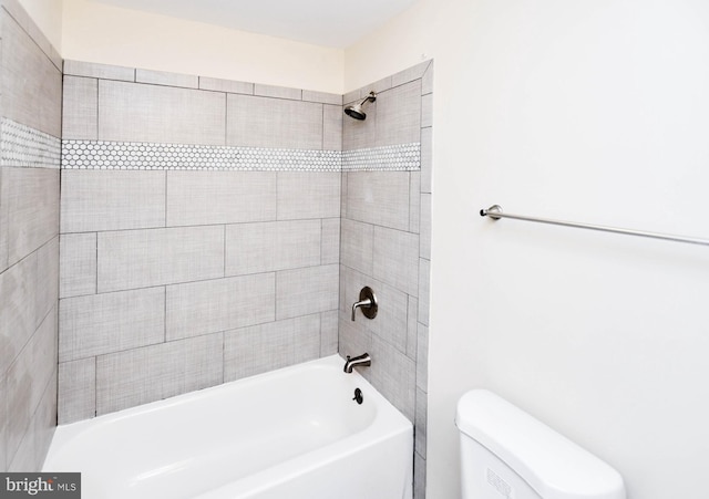 bathroom featuring toilet and bathing tub / shower combination