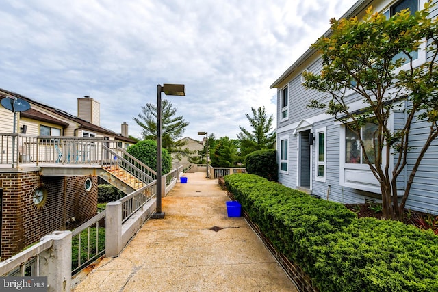 view of property's community with a deck and stairs