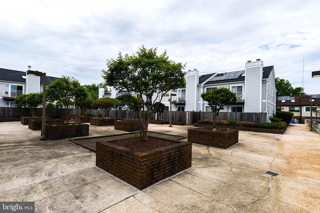 view of patio / terrace featuring fence and a residential view