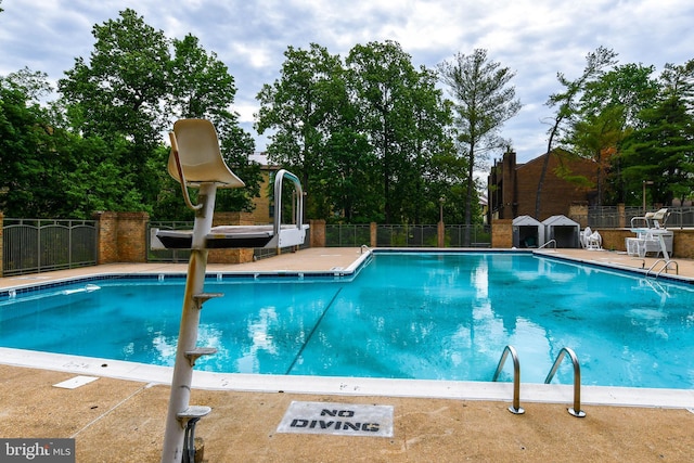 community pool featuring fence