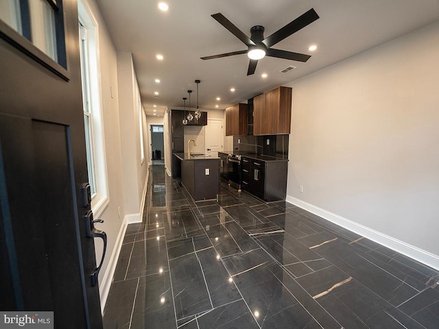 2005 N Lawrence St, Philadelphia, PA 19122 - kitchen with ceiling fan, baseboards, an island with sink, recessed lighting, and a sink