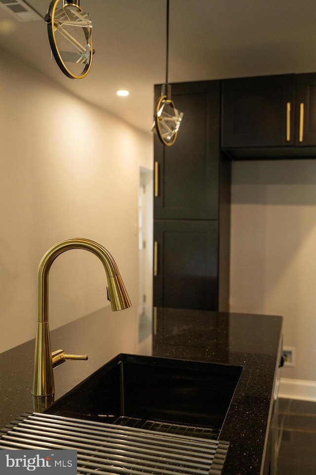 2005 N Lawrence St, Philadelphia, PA 19122 - kitchen view of a sink, recessed lighting, dark stone counters, dark cabinets, and baseboards