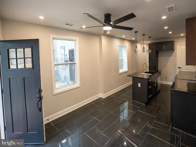 2005 N Lawrence St, Philadelphia, PA 19122 - kitchen with a sink, dark countertops, ceiling fan, baseboards, and recessed lighting