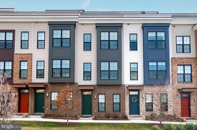 townhome / multi-family property with brick siding and entry steps