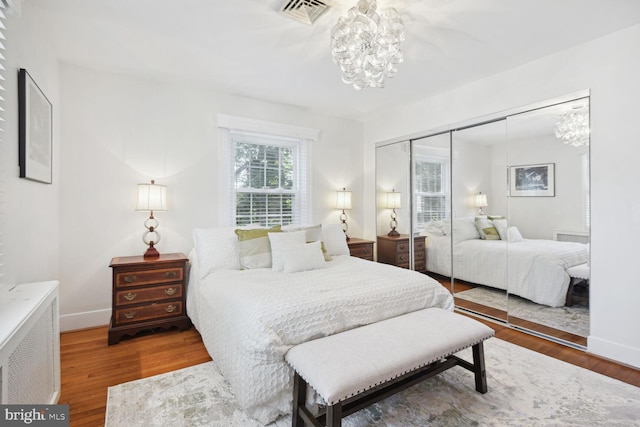 1614 Grace Church Rd, Silver Spring, MD 20910 - bedroom with an inviting chandelier, a closet, wood finished floors, and visible vents