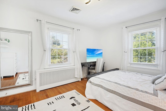 1614 Grace Church Rd, Silver Spring, MD 20910 - bedroom with visible vents, radiator, multiple windows, and wood-type flooring
