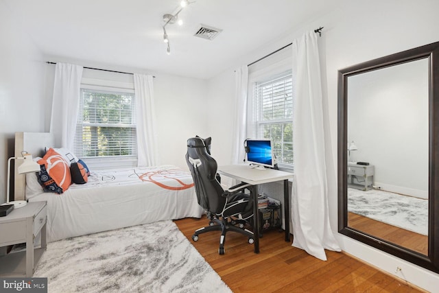 1614 Grace Church Rd, Silver Spring, MD 20910 - bedroom featuring visible vents, rail lighting, and wood finished floors