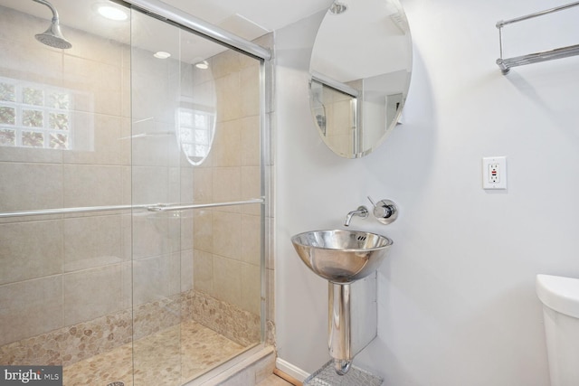 1614 Grace Church Rd, Silver Spring, MD 20910 - bathroom featuring toilet, baseboards, a shower stall, and a sink