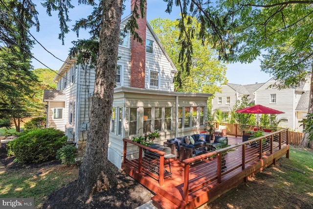 1614 Grace Church Rd, Silver Spring, MD 20910 - back of property with a wooden deck, a chimney, a sunroom, and outdoor lounge area