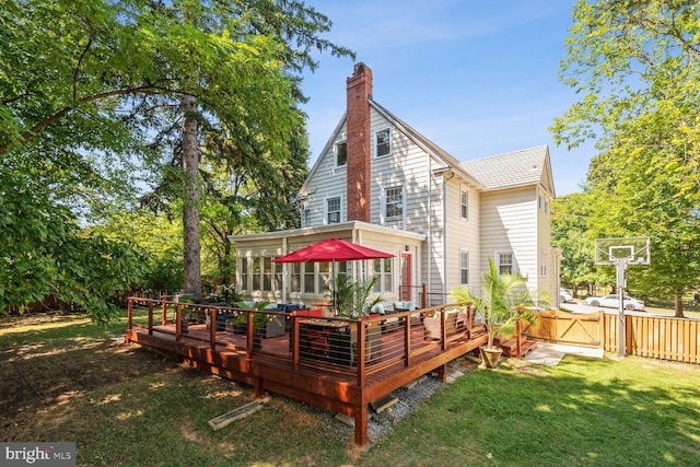 1614 Grace Church Rd, Silver Spring, MD 20910 - rear view of house featuring a wooden deck, fence, a chimney, a sunroom, and a yard