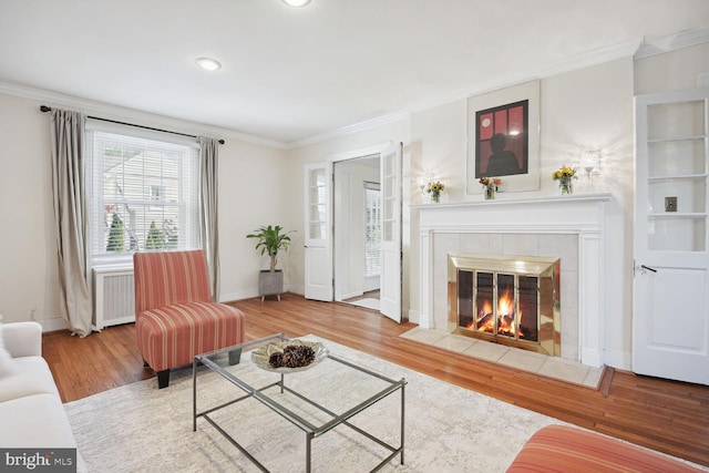 1614 Grace Church Rd, Silver Spring, MD 20910 - living area featuring crown molding, baseboards, wood finished floors, and a tile fireplace