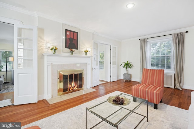 1614 Grace Church Rd, Silver Spring, MD 20910 - living area with a healthy amount of sunlight, ornamental molding, a fireplace, and wood finished floors